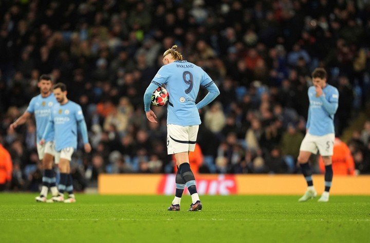 Manchester City's Erling Haaland, centre, walks dejected after Brugge's Raphael Onyedika, not in the picture, scored the opening goal during the Champions League opening phase soccer match between Manchester City and Club Brugge at the Etihad Stadium in Manchester, Wednesday, Jan. 29, 2025. (Martin Rickett/PA via AP)