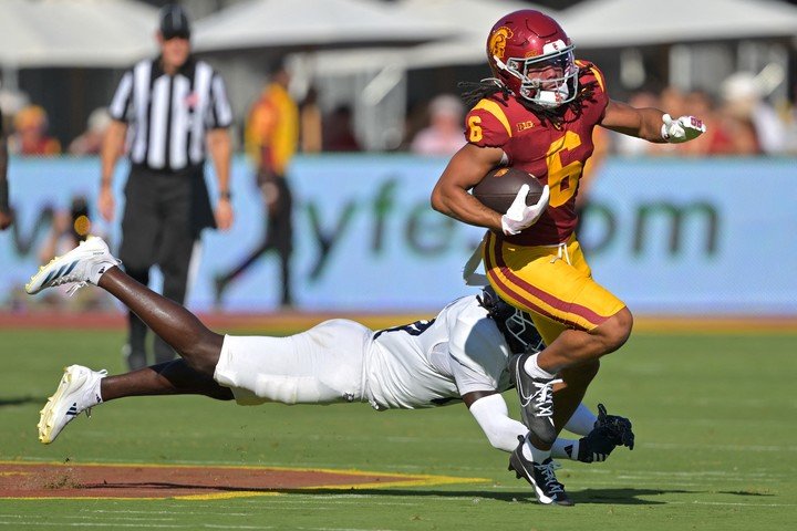 Sep 6, 2025; Los Angeles, California, USA; USC Trojans wide receiver Makai Lemon (6) gets past a diving Georgia Southern Eagles defensive back Prince Green III (14) for a short gain during the first half at the Los Angeles Memorial Coliseum. Mandatory Credit: Jayne Kamin-Oncea-Imagn Images