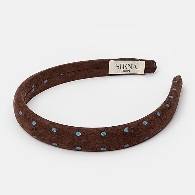 Diadema acolchada con topos azules de Siena, a la venta en El Corte Inglés, 10,95 euros.