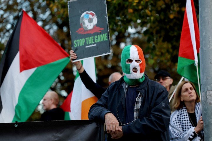 Hinchas irlandeses con banderas y máscaras por Palestina (Reuters).